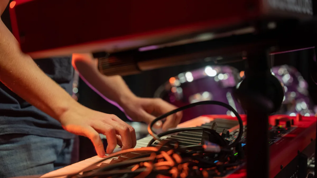 Hands playing a keyboard