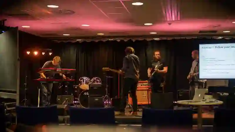 A group of musicians trying out ideas together on a stage